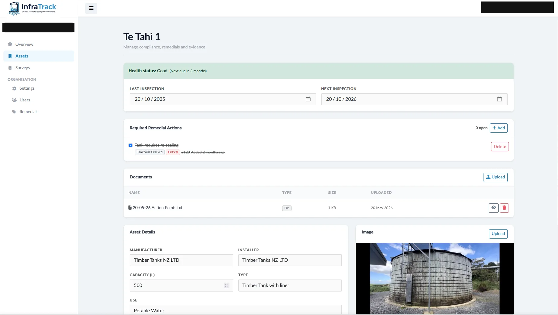InfraTrack asset page for a timber water tank showing health status, inspection dates, remedial actions, documents, and asset details with a photo